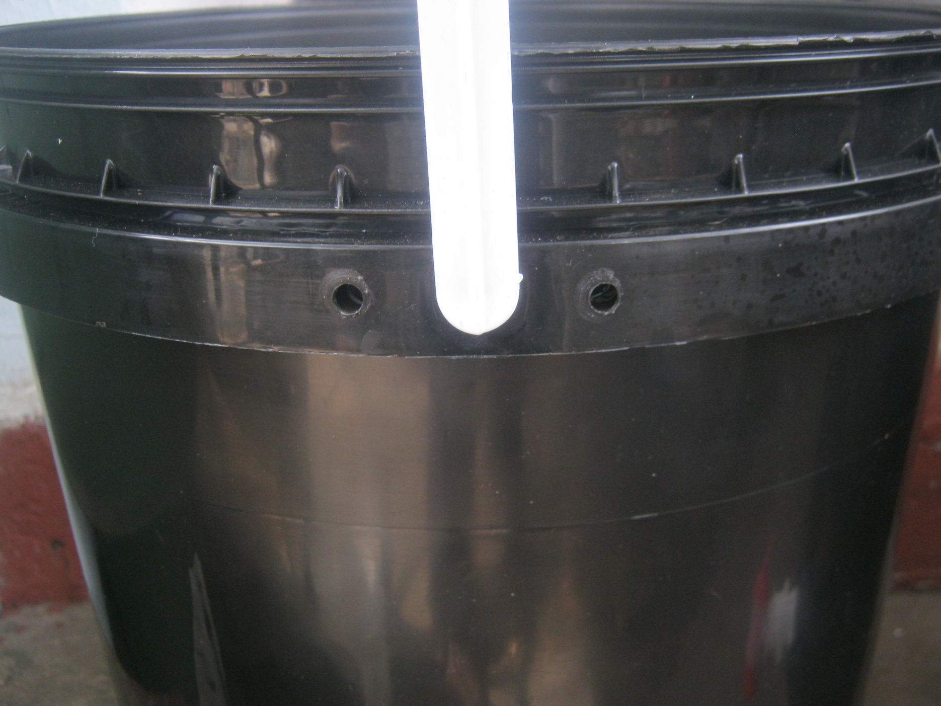 Working bin of a worm farm with 2 ventilation holes near the top of its side
